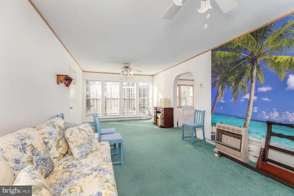 a bedroom with furniture and a large window