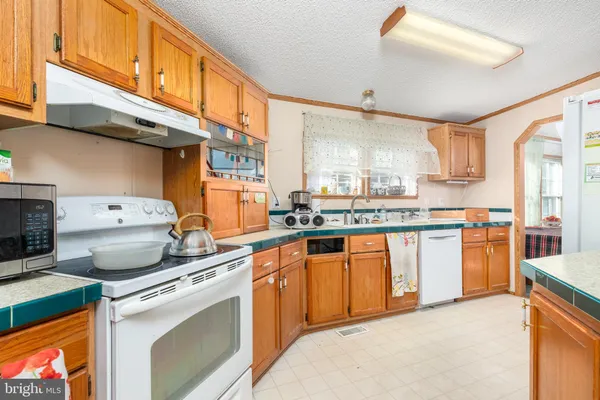a kitchen with a stove a sink and a refrigerator