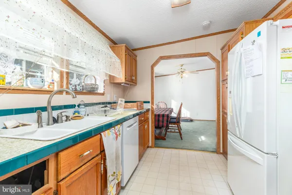 a kitchen with a sink refrigerator and cabinets