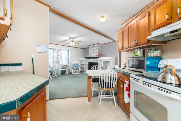 a kitchen with stainless steel appliances granite countertop a stove top oven a sink dishwasher and cabinets with wooden floor