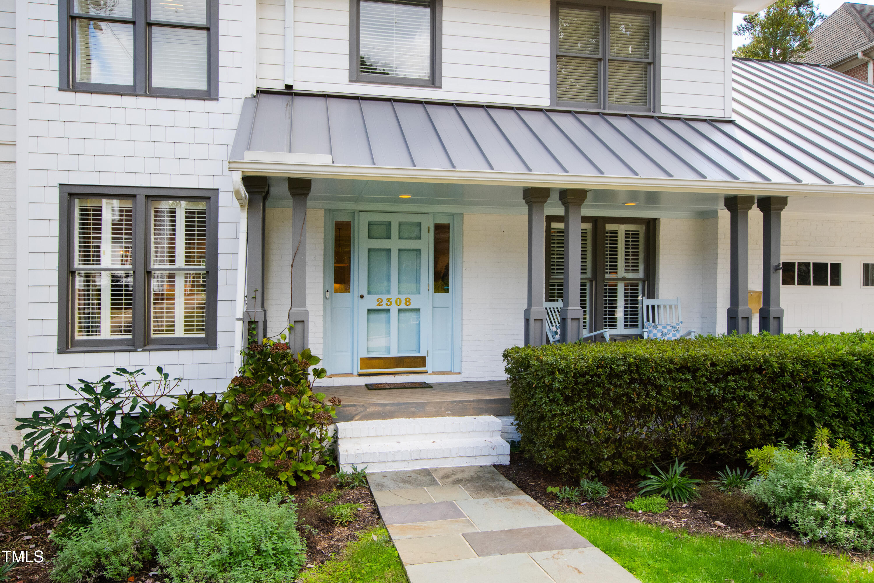 2308 Hales Road Raleigh, NC 27608 - Photo 3 of 5 front view of a brick house with potted plants
