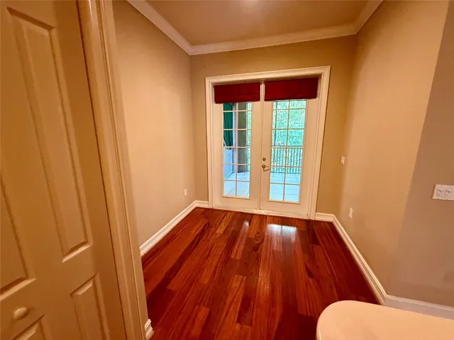 a view of front door with wooden floor
