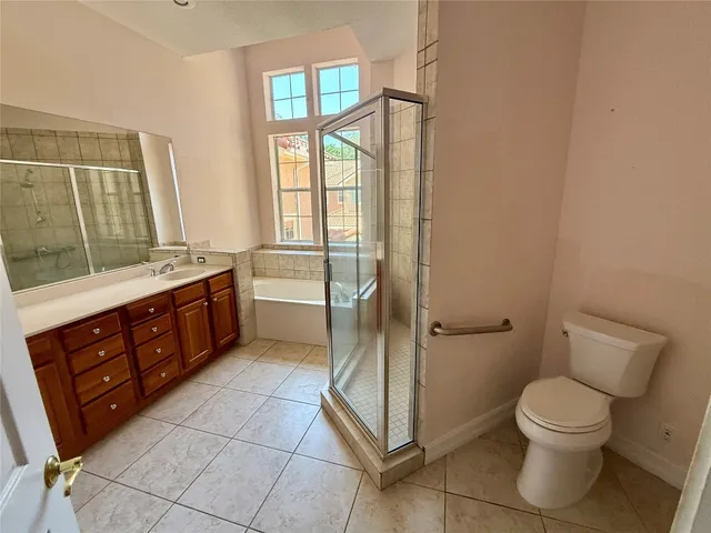 a bathroom with a toilet a sink and shower