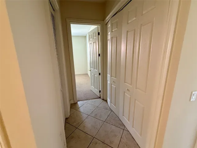 a view of a hallway with a wooden door