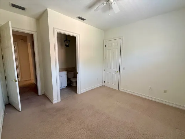 an empty room with closet and a bathroom