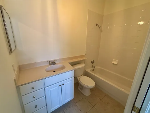a bathroom with a double vanity sink toilet mirror and shower