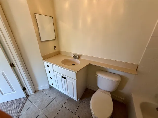 a bathroom with a sink toilet and mirror