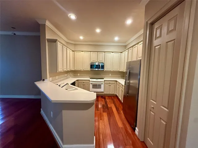 a kitchen that has a sink a refrigerator a washer and dryer