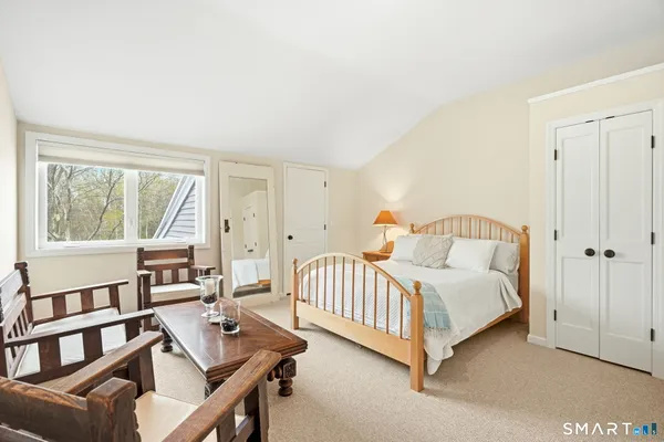 a bedroom with a bed and a table in it
