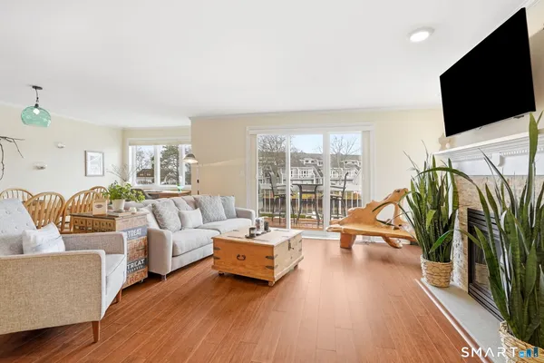 a living room with furniture large windows and a flat screen tv