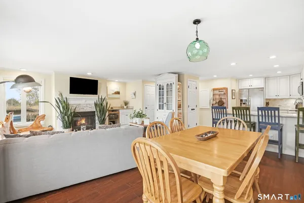 a dining room with furniture entryway and wooden floor