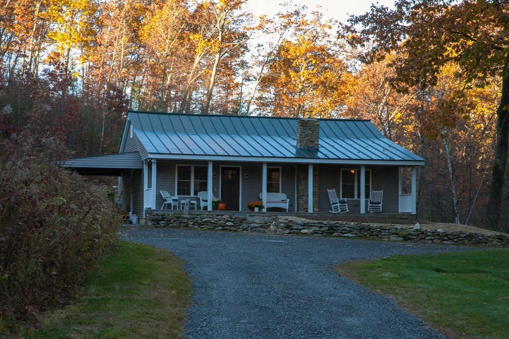 240 North Brookfield Road Oakham, MA 01068 - Photo 3 of 24 a front view of house with yard outdoor seating and green space
