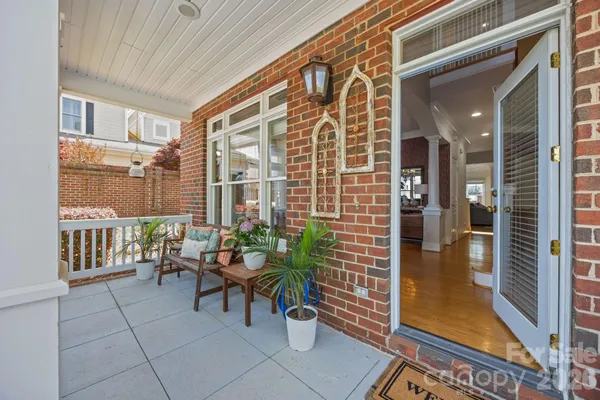 a balcony with furniture and a potted plant