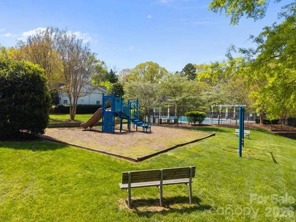 a swimming pool with some trees in the background