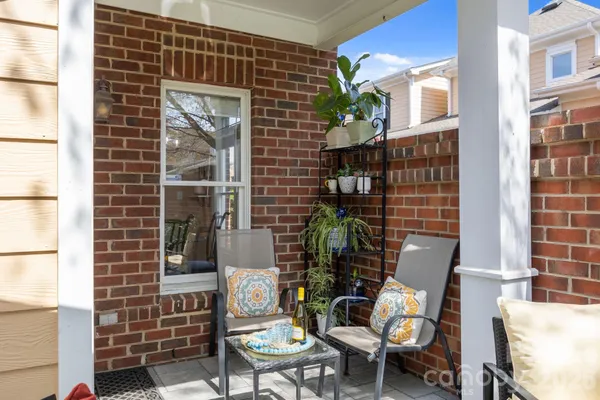 a front view of a house with outdoor seating