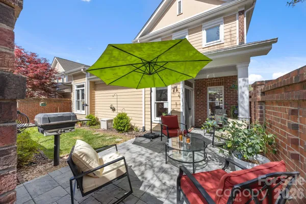 a view of a house with backyard and sitting area