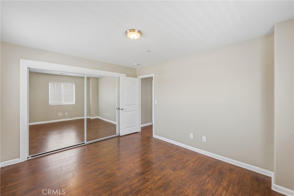 956 West Tibbot Street Rialto, CA 92377 - Photo 23 of 37 a view of an empty room with wooden floor and a window