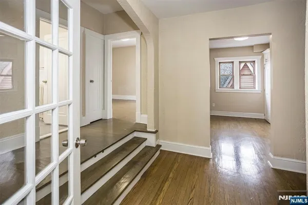 a view of a room with wooden floor and staircase