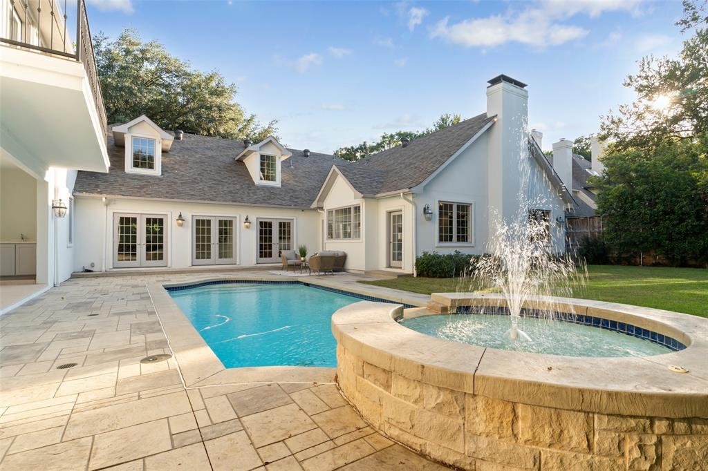 a view of a house with swimming pool and sitting area