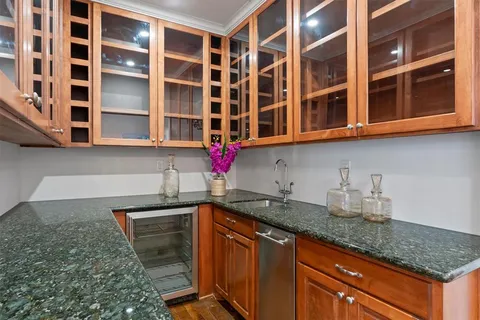 a kitchen with stainless steel appliances granite countertop a sink and cabinets