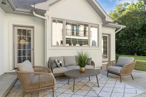 a view of a house with backyard and sitting area
