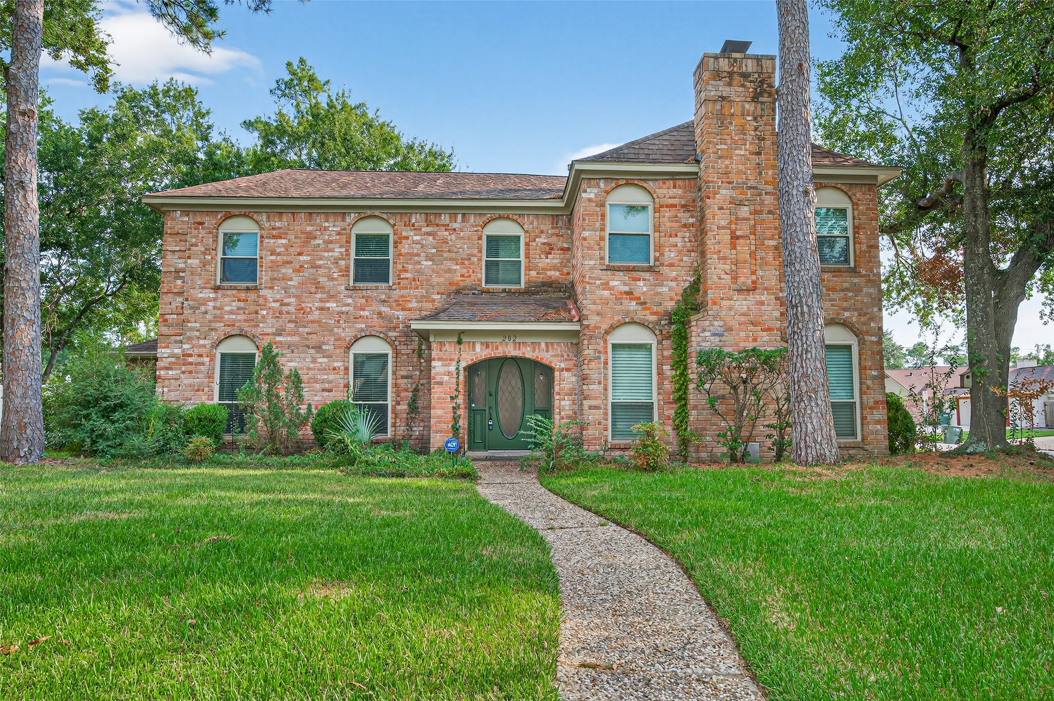 a front view of a house with a garden