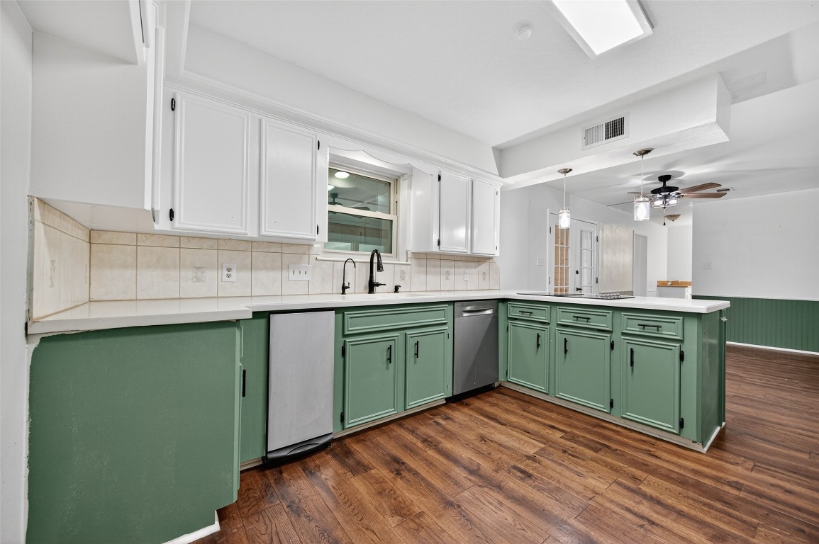 202 Laura Lane Conroe, TX 77385 - Photo 13 of 31 a kitchen with green cabinets and a sink
