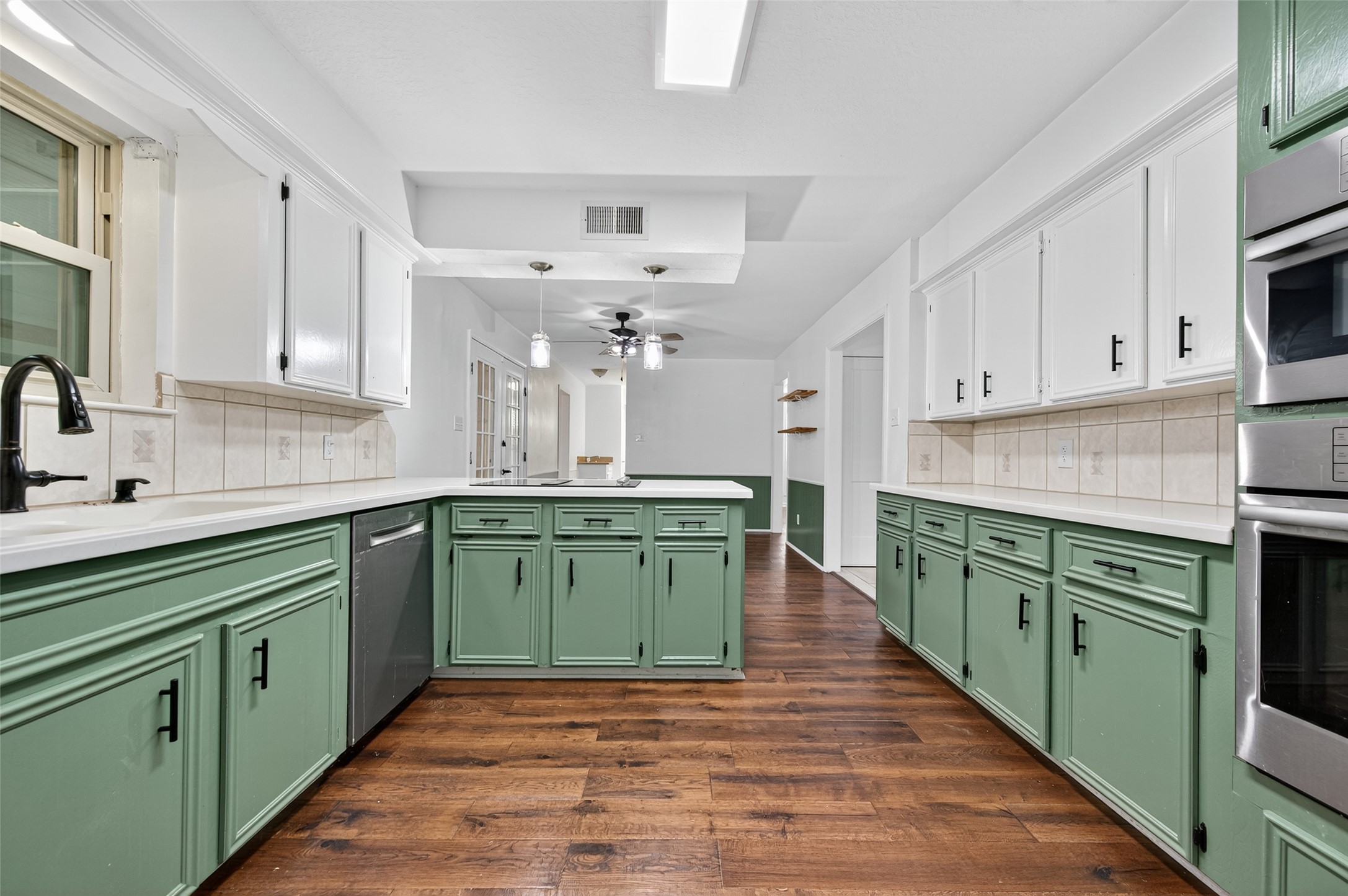 202 Laura Lane Conroe, TX 77385 - Photo 14 of 31 a kitchen with sink a stove and cabinets