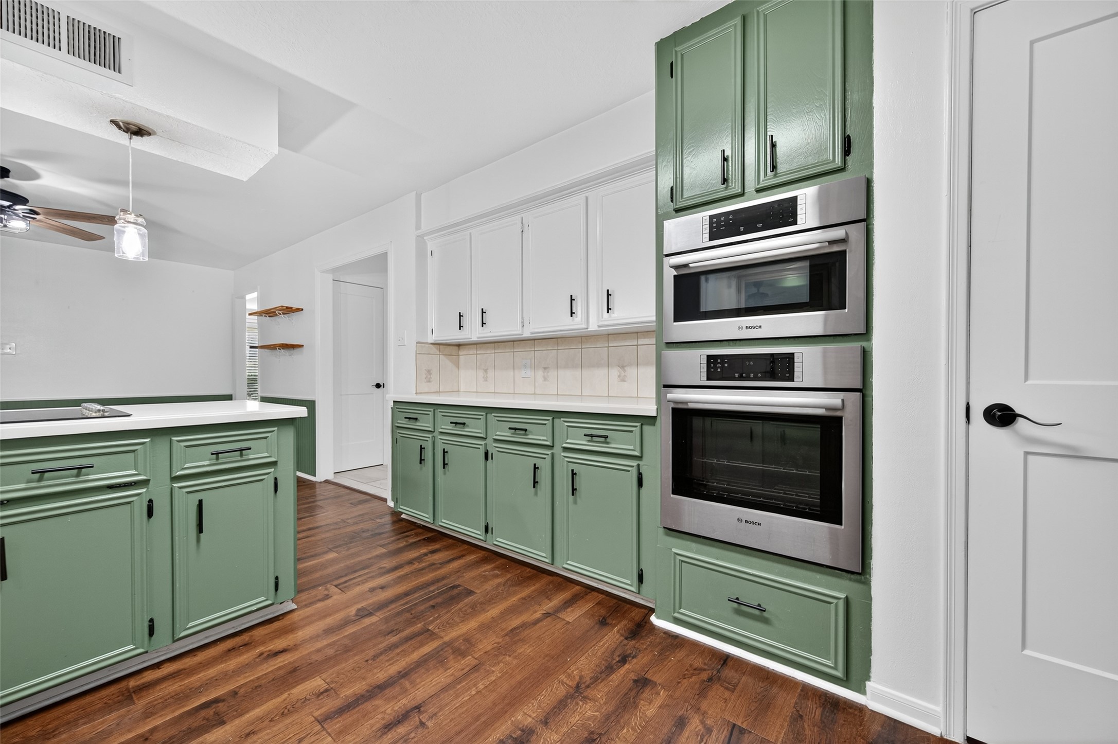 202 Laura Lane Conroe, TX 77385 - Photo 15 of 31 a kitchen with cabinets stainless steel appliances and wooden floor