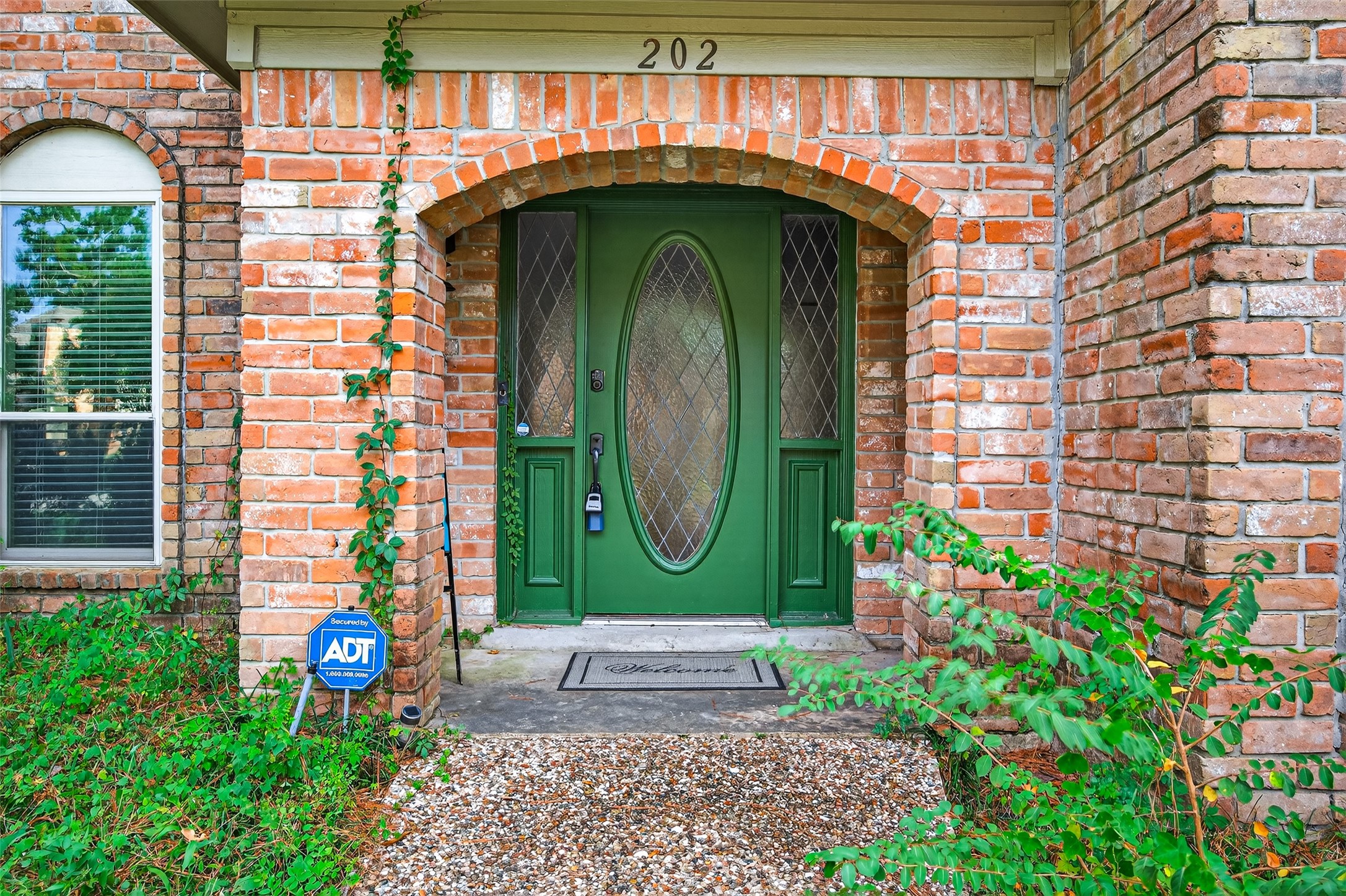202 Laura Lane Conroe, TX 77385 - Photo 2 of 31 a view of entrance gate of a house with a yard