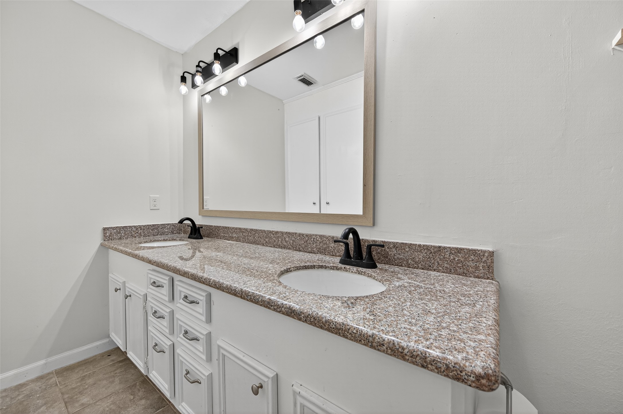 202 Laura Lane Conroe, TX 77385 - Photo 24 of 31 a bathroom with a granite countertop sink and a mirror
