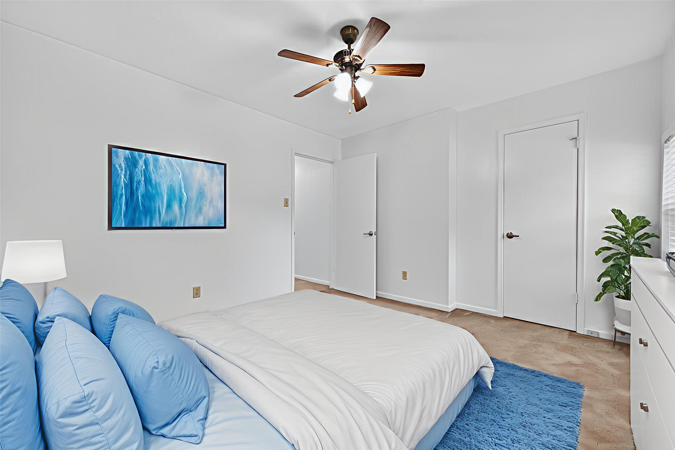 202 Laura Lane Conroe, TX 77385 - Photo 25 of 31 a bedroom with a bed and a chandelier