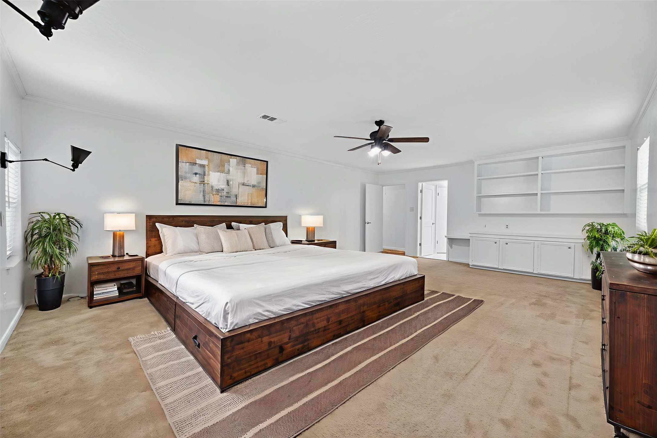 202 Laura Lane Conroe, TX 77385 - Photo 26 of 31 a spacious bedroom with a bed and potted plant