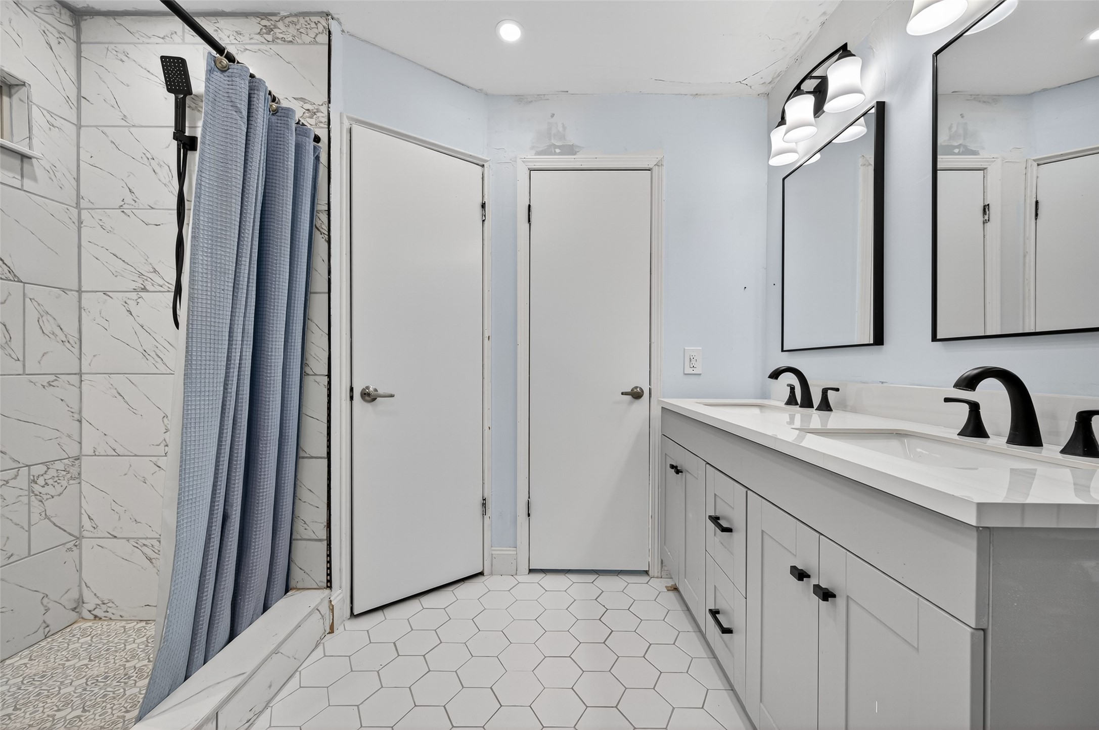 202 Laura Lane Conroe, TX 77385 - Photo 28 of 31 a bathroom with a double vanity sink and mirror
