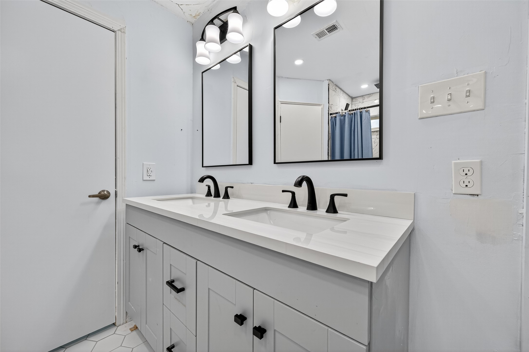 202 Laura Lane Conroe, TX 77385 - Photo 29 of 31 a bathroom with a sink vanity and a mirror