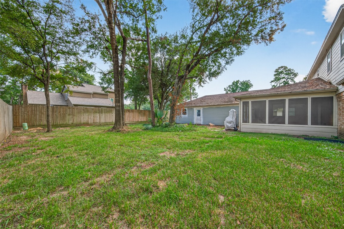 202 Laura Lane Conroe, TX 77385 - Photo 31 of 31 a view of a house with backyard and sitting area