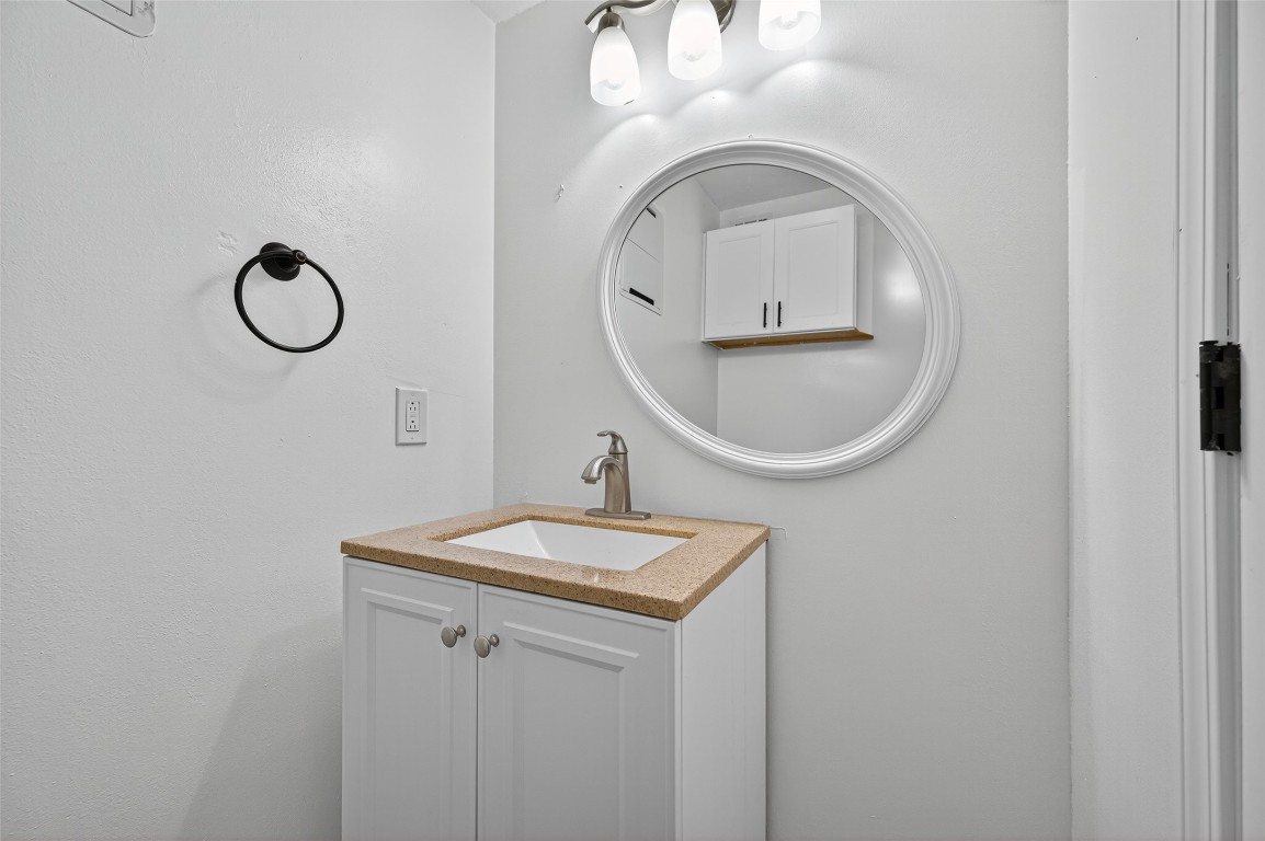 202 Laura Lane Conroe, TX 77385 - Photo 9 of 31 a bathroom with a sink and a mirror