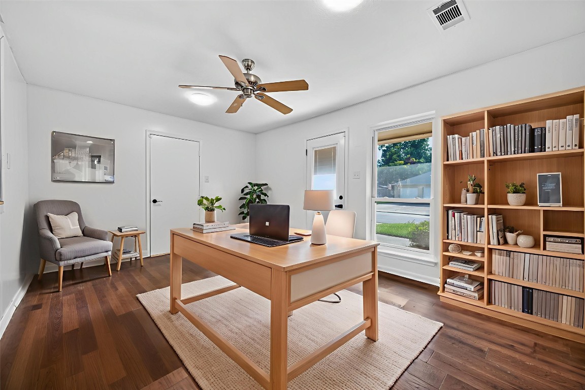 202 Laura Lane Conroe, TX 77385 - Photo 10 of 31 a view of a workspace with furniture and a book shelf