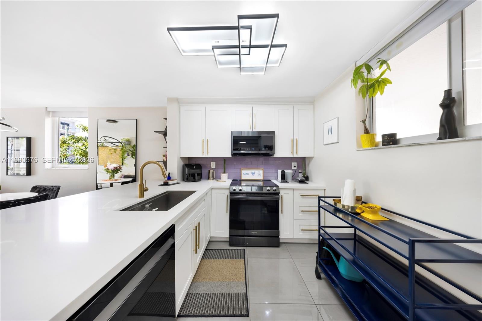 1665 Bay Road, Unit 221 Miami Beach, FL 33139 - Photo 12 of 33 a kitchen with a sink appliances and cabinets