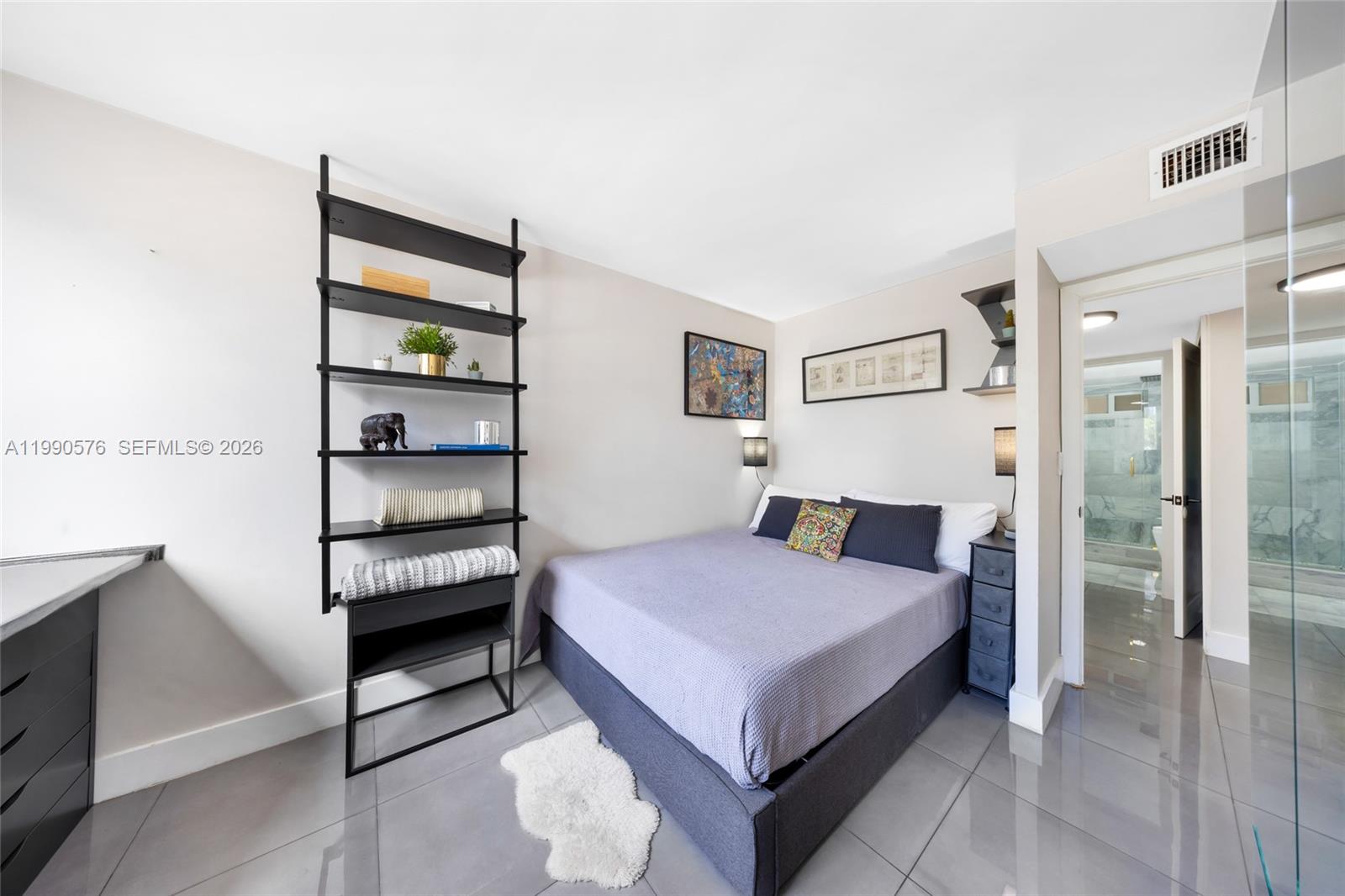 1665 Bay Road, Unit 221 Miami Beach, FL 33139 - Photo 17 of 33 a bedroom with a bed and a window