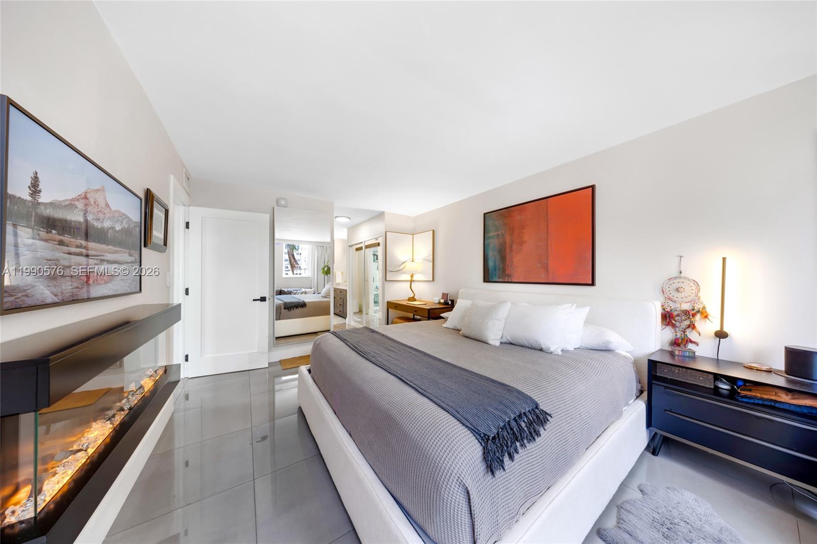 1665 Bay Road, Unit 221 Miami Beach, FL 33139 - Photo 21 of 33 a spacious bedroom with a bed and a dresser in it