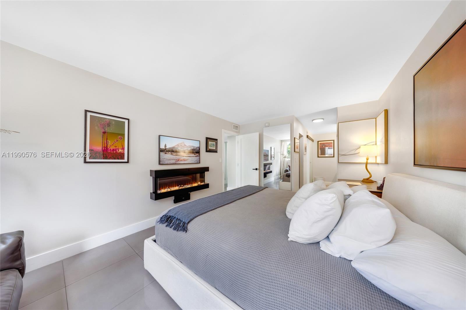 1665 Bay Road, Unit 221 Miami Beach, FL 33139 - Photo 22 of 33 a bedroom with a bed and a flat screen tv