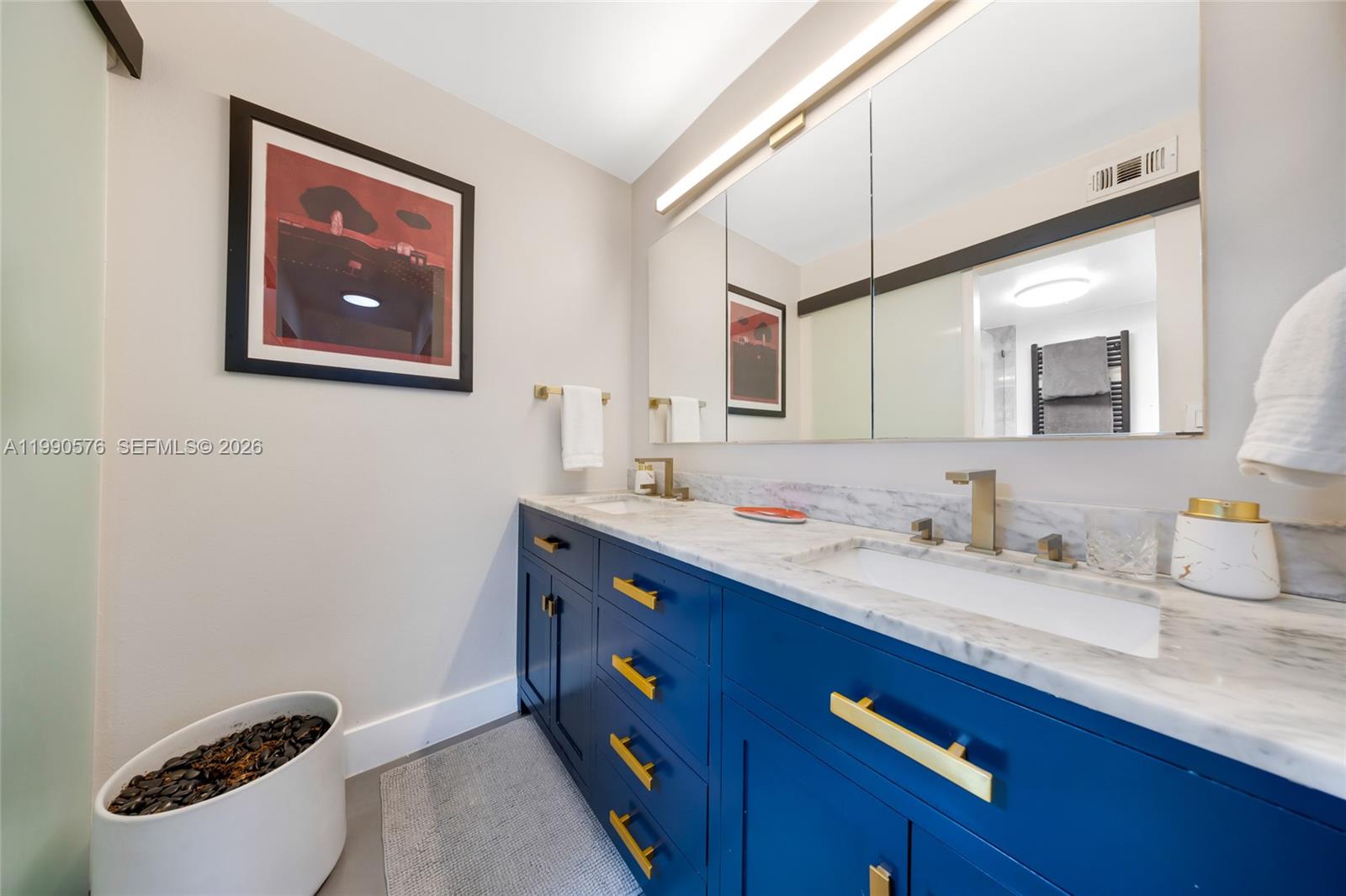 1665 Bay Road, Unit 221 Miami Beach, FL 33139 - Photo 24 of 33 a bathroom with a double vanity sink and mirror