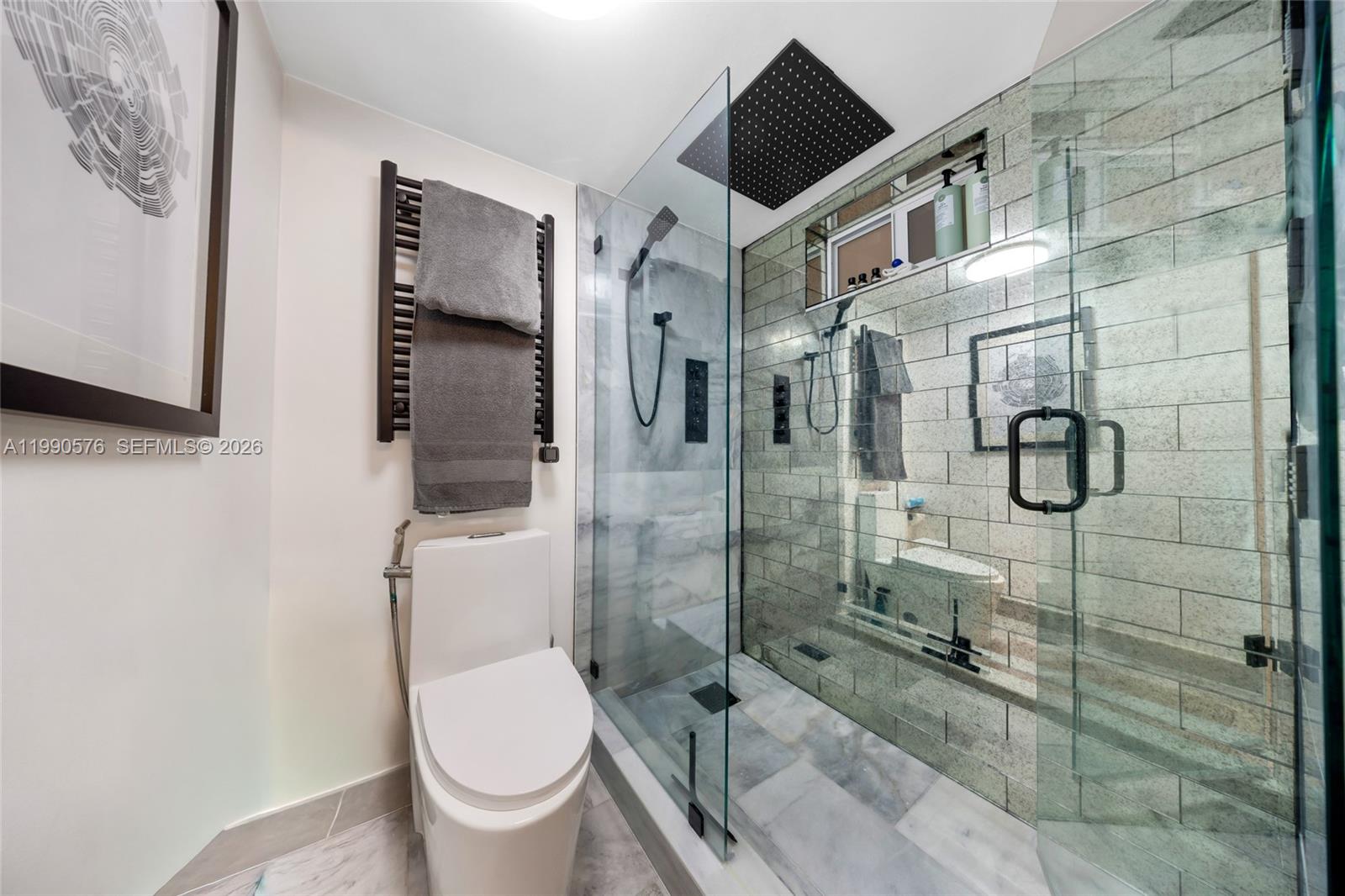 1665 Bay Road, Unit 221 Miami Beach, FL 33139 - Photo 25 of 33 a bathroom with a toilet and a shower
