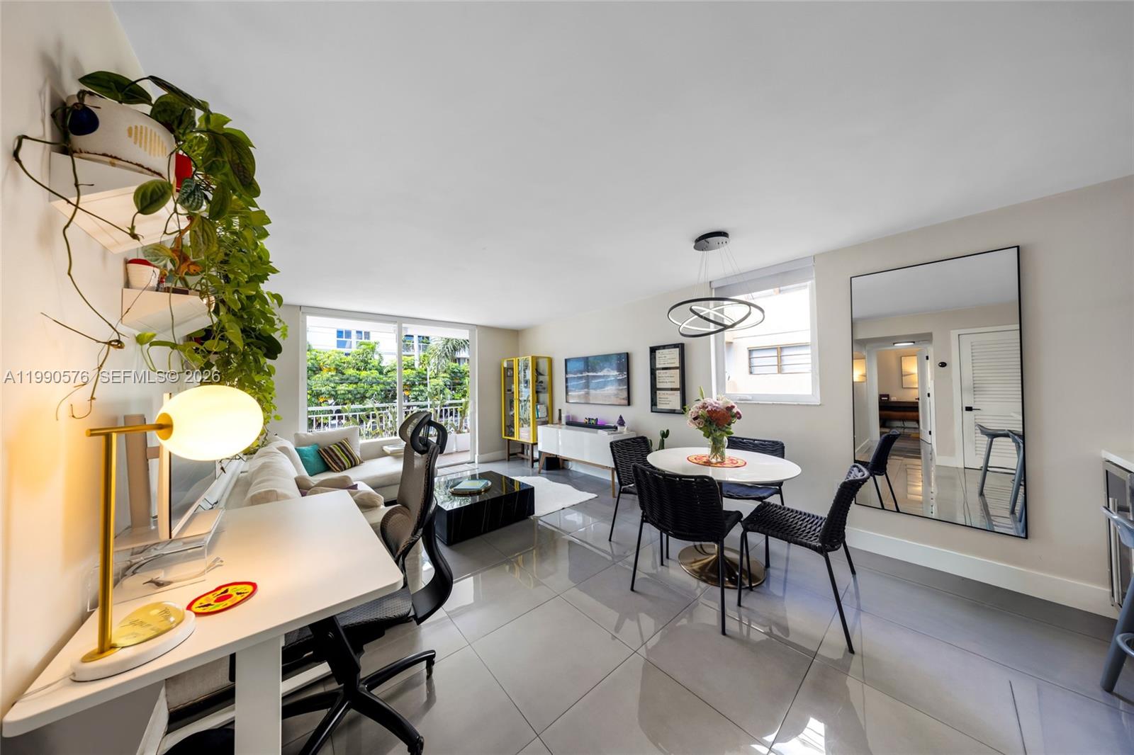 1665 Bay Road, Unit 221 Miami Beach, FL 33139 - Photo 3 of 33 a living room with furniture and a large window