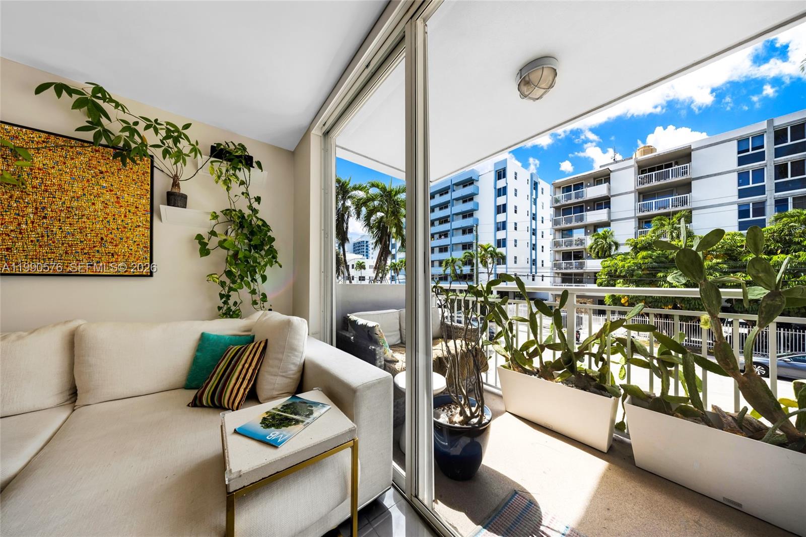 1665 Bay Road, Unit 221 Miami Beach, FL 33139 - Photo 6 of 33 a living room with furniture and flowers