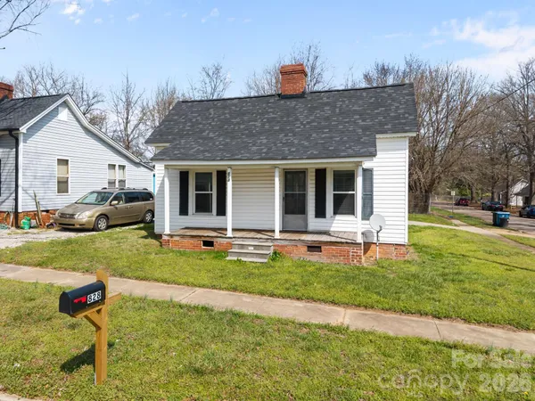 a front view of house with yard and outdoor seating