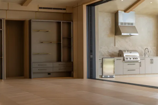 a dining room with furniture and a floor to ceiling window