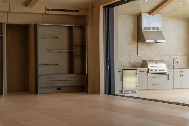 a dining room with furniture and a floor to ceiling window