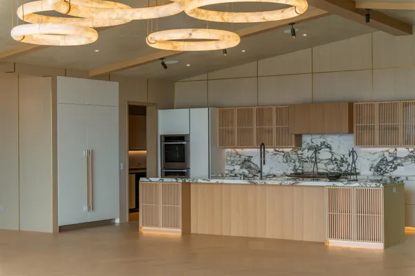 a bathroom with a granite countertop sink a large mirror and shower
